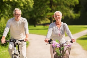 Happy elderly couple riding bicycles