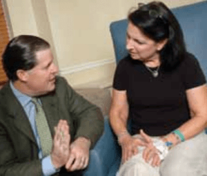 Dr. Dalury speaks with patient following total knee replacement
