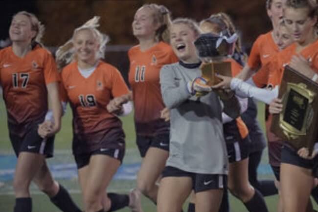 Taylor (2nd from left) celebrates with teammates after beating Archbishop Spalding, 5-0, in the IAAM A Conference soccer championship game Nov. 3 at Anne Arundel Community College.