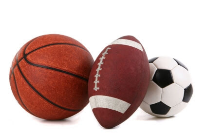 A basketball, a football, and a soccer ball